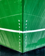 Abstract image of the depth line of a ship with green hull, white lettering