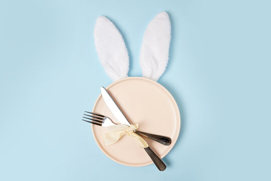 festive Easter table setting with white Easter Bunny ears