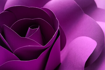 Beautiful purple flower made of paper as background, closeup