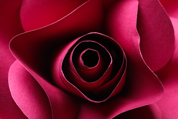 Beautiful red flower made of paper as background, top view
