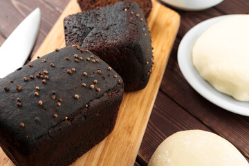 Sliced rye bread on brown wooden background