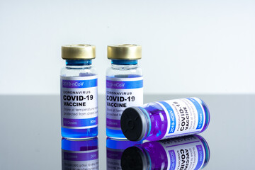 Medical concept ampoules or vials with Covid-19 vaccine on a laboratory bench