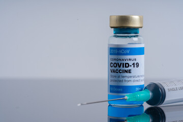Medical concept ampoules or vials with Covid-19 vaccine on a laboratory bench