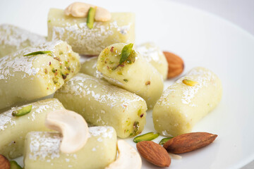 Detailed Closeup Of Kaju Pista Roll Or Cashew Pistachio Roll Mithai Is Made Of Grated Cashews Mixed With Crumbled Khoya Mawa Kesar Mava Elaichi Khoa In Ghee And Blanched With Almonds And Dry Fruits