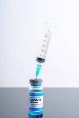 Medical concept ampoules or vials with Covid-19 vaccine on a laboratory bench