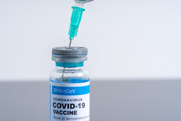 Medical concept ampoules or vials with Covid-19 vaccine on a laboratory bench