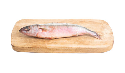 Red-eyed sea fish on a wooden kitchen board on a white background, isolate. reshness