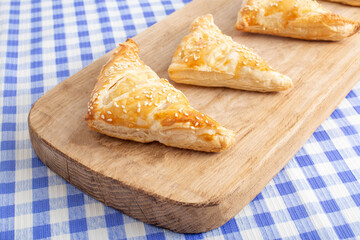 Delicious crunchy puffs with ham and cheese on a checkered background. homemade baking. Appetizer