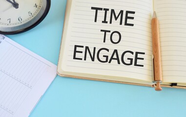 Time to engage text written in Notebook. Lightblue background. Business concept for Engagement Involvement.