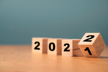 Flipping of wooden cube block for change 2021 to 2022 year , Preparation for merry Christmas and happy new year concept. - obrazy, fototapety, plakaty