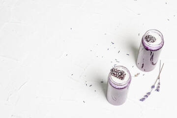 Lavender smoothie with coconut flakes and frozen blackberry