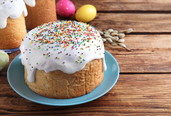 Traditional decorated Easter cake on wooden table. Space for text