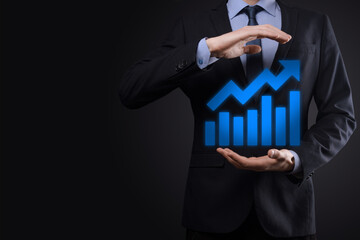 Businessman hold drawing on screen growing graph, arrow of positive growth icon.pointing at creative business chart with upward arrows.Financial, business growth concept