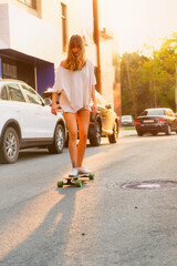 Young woman riding a skateboard in the city