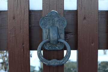 Old metal iron door knocker with entrance. 