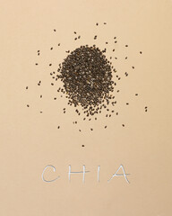 Bright background with scattered chia seeds. Signed background with chia seeds. Superfood, healthy lifestyle, healthy eating.