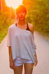 Portrait of a young woman in the summer at sunset