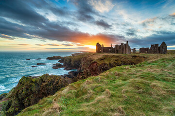 Fototapeta na wymiar Dramatic sunset over the ruins Slains Castle