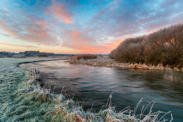 A frosty winter sunrise over the river Frome