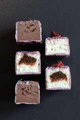 Dessert in a cut on a black background. Vegetarian glazed cheese, dessert for vegan children. Sugar free concept.