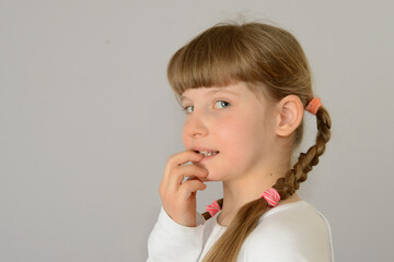 kid child beautiful cute little girl biting her nails concept photo