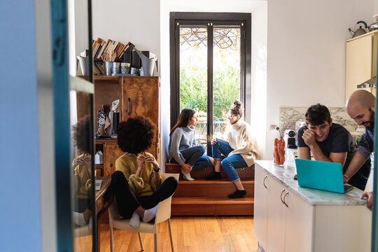 Housemates together in kitchen