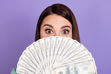 Photo of young businesswoman covering half face mouth with fan of money dollars isolated on purple color background