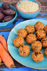 Carrot oat date energy balls. Gluten free and vegan food. Wooden background