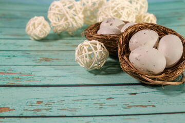 egg in nest on blue wooden background