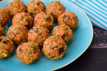 Carrot oat date energy balls. Gluten free and vegan food. Wooden background