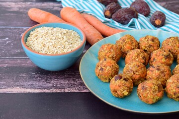 Carrot oat date energy balls. Gluten free and vegan food. Wooden background