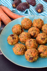 Carrot oat date energy balls. Gluten free and vegan food. Wooden background