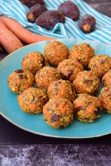 Carrot oat date energy balls. Gluten free and vegan food. Wooden background