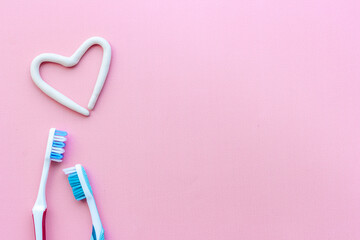 Teeth hygiene. Toothbrush with heart shape made of toothpaste, top view