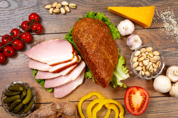 Assortment of cold cuts, a variety of processed cold meat products. On a wooden background