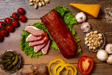 Assortment of cold cuts, a variety of processed cold meat products. On a wooden background