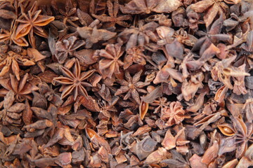 A lot dried Star Anis spices ingredient for food cooking, natural background texture