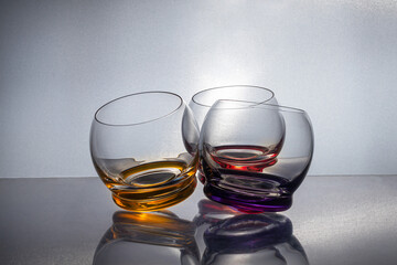 Wine glasses with a colored bottom on a dark background. Dishes for wine and other drinks.