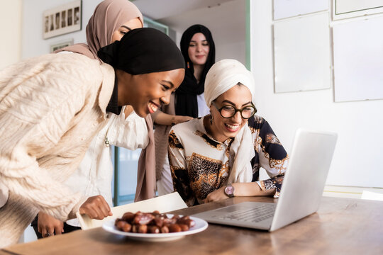 Young muslim women on video call, with plate of dates