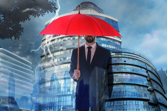 Businessman With Umbrella In City Center. Insurance Concept