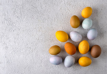 Modern natural dyed easter eggs. Happy Easter. Congratulatory easter background. Easter composition on grey concrete backgrount.