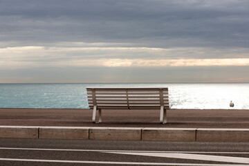 Rear view of bench on beach, Nice, Alpes-Maritimes, France