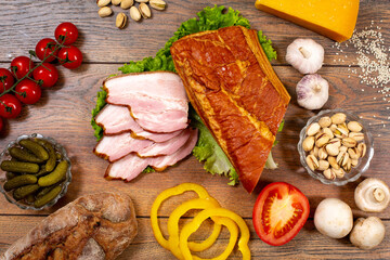 Assortment of cold cuts, a variety of processed cold meat products. On a wooden background