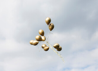 Gold balloons flying away, Piotrkow Trybunalski, Lodz Voivodeship, Poland