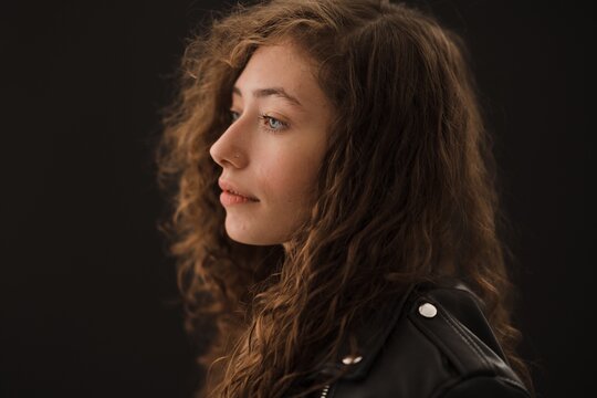 Studio Shot Of Young Woman With Long Curly Hair