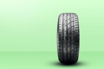 new summer tire. front view, green spring background, copy space