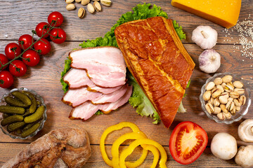 Assortment of cold cuts, a variety of processed cold meat products. On a wooden background