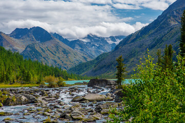 View of the snowy peaks from the noises of the second multinsky lake in the mountains of Altai