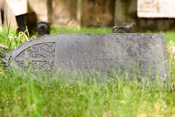 Fallen tombstone in cemetery, Wschowa, Lubusz Voivodeship, Poland