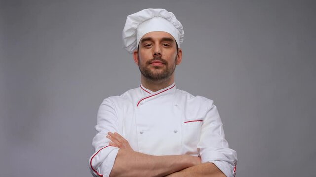 cooking, culinary and people concept - male chef in toque and jacket over grey background